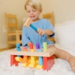 Medinė daužyklė su šokinėjančiais žmogeliais