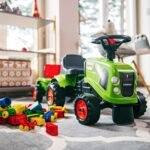 Stumiamasis traktoriukas Baby Claas žalias su priekaba ir priedais